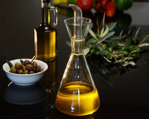 Extra virgin olive oil being poured over a dish